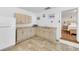 Bright kitchenette with cabinets, sink, microwave, mini-fridge, and an entryway to a bedroom at 7360 Fields Dr, Cumming, GA 30041
