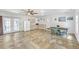 Spacious living room featuring tile flooring, a ceiling fan, double doors, a dining table and kitchenette at 7360 Fields Dr, Cumming, GA 30041