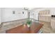 Open concept living room with tile floors, kitchenet and white walls with a dining table in the middle at 7360 Fields Dr, Cumming, GA 30041