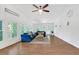 Bright living room features wood floors, lots of windows, ceiling fan, and vaulted ceiling at 7360 Fields Dr, Cumming, GA 30041