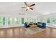 Bright living room features wood floors, lots of windows, and vaulted ceiling at 7360 Fields Dr, Cumming, GA 30041