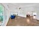 Spacious living room with wood floors, lots of windows, ceiling fan, and vaulted ceiling at 7360 Fields Dr, Cumming, GA 30041
