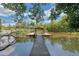 Scenic waterfront view featuring a private dock and serene surroundings at 7360 Fields Dr, Cumming, GA 30041