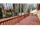 A wood deck and railing overlook an outdoor space that could be used for recreational activities at 1343 Willow Sw Trl, Atlanta, GA 30311