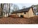 A view of the back exterior of the home with a wood deck and natural landscaping at 1343 Willow Sw Trl, Atlanta, GA 30311