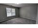 This bedroom features plush carpeting, a window for natural light, and neutral wall paint at 1343 Willow Sw Trl, Atlanta, GA 30311
