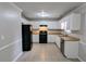 Well-lit kitchen with white cabinets, dark appliances, and tile flooring at 1343 Willow Sw Trl, Atlanta, GA 30311
