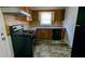 Kitchen with wooden cabinets, laminate countertops, and black appliances at 2914 Wanda Sw Cir, Atlanta, GA 30315
