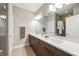 Modern bathroom featuring double sinks, sleek cabinets, and a glass-enclosed shower with refined, contemporary decor at 6657 Encore Blvd, Atlanta, GA 30328