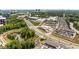 Aerial shot of a mixed use building with townhomes, a pond, and easy access to surrounding roads and buildings at 6657 Encore Blvd, Atlanta, GA 30328