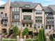 Stunning townhome features a well-manicured lawn, and private entrances, a sophisticated look with grey and white brick facade at 6657 Encore Blvd, Atlanta, GA 30328