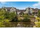 Beautiful building exterior with lush landscaping, walking bridge, and serene water feature at 6657 Encore Blvd, Atlanta, GA 30328