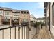 Townhome community exterior showing garage parking and balcony view from deck with refined home architectural design at 6657 Encore Blvd, Atlanta, GA 30328