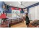 Sports themed bedroom with pennants, natural light, and a desk for work or gaming at 154 Hunters Trl, Dallas, GA 30157