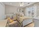 Charming bedroom featuring a ceiling fan and a window with decorative curtains and natural light at 154 Hunters Trl, Dallas, GA 30157