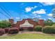 Charming brick entrance to Hunter's Glen neighborhood under a blue sky at 154 Hunters Trl, Dallas, GA 30157