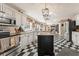 Well-lit kitchen featuring stainless steel appliances, granite countertops, and checkered flooring at 154 Hunters Trl, Dallas, GA 30157