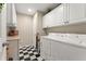 Functional laundry room with white cabinets, granite countertop, washer, and dryer at 154 Hunters Trl, Dallas, GA 30157