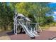 Community playground structure with slide, swing set and pea gravel at 154 Hunters Trl, Dallas, GA 30157