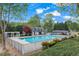 Community pool surrounded by lush greenery and a charming pool house at 154 Hunters Trl, Dallas, GA 30157