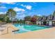 Sparkling community pool with sundeck and lounge chairs on a sunny day at 154 Hunters Trl, Dallas, GA 30157