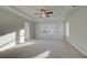 Main bedroom with carpet, tray ceiling with ceiling fan, two windows and recessed lighting at 325 Heavenly Hollow Pl, Mcdonough, GA 30253