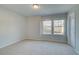 Bedroom featuring carpet floors, double windows, and a closet at 325 Heavenly Hollow Pl, Mcdonough, GA 30253