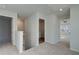 Upstairs hallway with carpet flooring leads to bedrooms and laundry room at 325 Heavenly Hollow Pl, Mcdonough, GA 30253