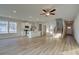 Sunlit living room with hardwood floors, kitchen with island, staircase, and light gray colored walls at 325 Heavenly Hollow Pl, Mcdonough, GA 30253