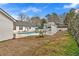 Backyard featuring a pool, deck, white fencing, and lush landscaping at 4087 Glenn Rd, Powder Springs, GA 30127