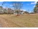 Expansive front yard featuring mature trees, providing ample space and privacy at 4087 Glenn Rd, Powder Springs, GA 30127