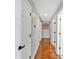 Hallway with hardwood floors and white doors with black hardware at 4087 Glenn Rd, Powder Springs, GA 30127