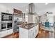 Well-equipped kitchen featuring a gas cooktop, double ovens, and stainless steel refrigerator at 4087 Glenn Rd, Powder Springs, GA 30127