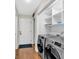 Well-lit laundry room equipped with modern, front-loading washer and dryer at 4087 Glenn Rd, Powder Springs, GA 30127