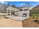 Outdoor kitchen on a wooden deck with a grill and a seating area, adjacent to the pool at 4087 Glenn Rd, Powder Springs, GA 30127