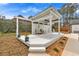 Outdoor kitchen featuring white wooden beams and neutral patio furniture, next to the pool at 4087 Glenn Rd, Powder Springs, GA 30127