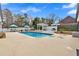 Backyard pool with lounge chairs, umbrellas, and a covered outdoor kitchen and dining area at 4087 Glenn Rd, Powder Springs, GA 30127