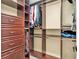 Organized walk-in closet with dark wood built-ins and ample storage space at 4087 Glenn Rd, Powder Springs, GA 30127