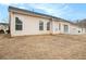 Home's backyard with a beige exterior and sliding glass door at 503 Goldfinch Way, Stockbridge, GA 30281