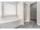 Bathroom with soaking tub, glass enclosed shower, and tile flooring that leads into the walk in closet at 503 Goldfinch Way, Stockbridge, GA 30281