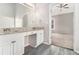 Primary bathroom boasts dual vanities and a doorway leading to a carpeted bedroom at 503 Goldfinch Way, Stockbridge, GA 30281