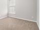 Cozy bedroom with neutral carpet, white trim, and a bright window at 503 Goldfinch Way, Stockbridge, GA 30281