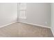 Small carpeted bedroom with a window view of the neighborhood and light colored walls at 503 Goldfinch Way, Stockbridge, GA 30281