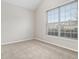 Neutral bedroom featuring a large window with blinds, carpeted floors, and ample natural light at 503 Goldfinch Way, Stockbridge, GA 30281