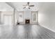 Bright living room featuring a cozy fireplace, ample natural light, and modern flooring at 503 Goldfinch Way, Stockbridge, GA 30281