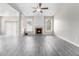 Living room featuring wood-look floors, fireplace, and abundant natural light at 503 Goldfinch Way, Stockbridge, GA 30281