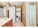 Bathroom featuring a single vanity, wallpaper, and doorways to other rooms at 6068 Magnolia Rdg, Stone Mountain, GA 30087