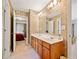 Bathroom featuring a double vanity, ornate wallpaper, and doorways to other rooms at 6068 Magnolia Rdg, Stone Mountain, GA 30087