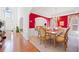 Formal dining room featuring an open floor plan, bright red walls, and hardwood floors at 6068 Magnolia Rdg, Stone Mountain, GA 30087