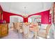 Formal dining room featuring an open floor plan, bright red walls, and hardwood floors at 6068 Magnolia Rdg, Stone Mountain, GA 30087